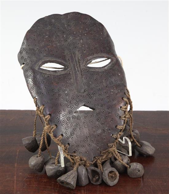 A tribal carved bone mask, 8.5in.